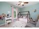 Bright bedroom with wooden bed frame, decor, and natural light at 6490 Ivey Hill Dr, Cumming, GA 30040