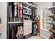 Organized walk-in closet with custom shelving and clothing racks and natural light at 6490 Ivey Hill Dr, Cumming, GA 30040