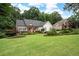Spacious front yard with a well-maintained lawn and landscaping showcasing the home's classic architectural design and curb appeal at 6490 Ivey Hill Dr, Cumming, GA 30040