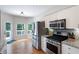 Well-lit kitchen features stainless steel appliances and access to the outdoor deck at 6490 Ivey Hill Dr, Cumming, GA 30040