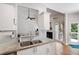 Bright kitchen with granite countertops, stainless steel sink, and white cabinetry at 6490 Ivey Hill Dr, Cumming, GA 30040
