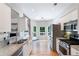 Kitchen features stainless appliances, grey backsplash, granite counters, & access to deck at 6490 Ivey Hill Dr, Cumming, GA 30040