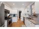 Modern kitchen with stainless steel appliances, granite countertops, white cabinets, and a stylish backsplash, offering both style and functionality at 6490 Ivey Hill Dr, Cumming, GA 30040
