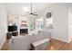 Bright living room with vaulted ceilings, fireplace, large sectional sofa, and an open view to the kitchen and dining area at 6490 Ivey Hill Dr, Cumming, GA 30040
