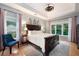 Spacious main bedroom with tray ceiling, natural light, and hardwood flooring at 6490 Ivey Hill Dr, Cumming, GA 30040