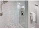 Shower with patterned tile floor and glass enclosure, next to a towel rack at 6490 Ivey Hill Dr, Cumming, GA 30040