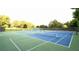 Well-maintained tennis courts surrounded by trees and fencing provide ample space for recreational activities at 6490 Ivey Hill Dr, Cumming, GA 30040