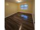Bedroom with new flooring, window, natural light, base molding, and neutral walls at 6851 Roswell Rd # 15, Atlanta, GA 30328