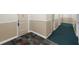 Neutral hallway with green carpet and tile flooring and paneled doors, providing a clean and functional space at 6851 Roswell Rd # 15, Atlanta, GA 30328