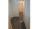 Hallway featuring wood floors leading to closets and the entry door at 6851 Roswell Rd # 15, Atlanta, GA 30328