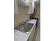 Bright kitchen featuring a stainless steel sink, faucet, and countertop, complemented by white cabinetry at 6851 Roswell Rd # 15, Atlanta, GA 30328