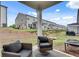 Relaxing back porch offers comfortable seating and serene views of the backyard and landscaping at 1542 Villageside Ct, Lawrenceville, GA 30043