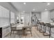 Bright dining area featuring a large table, bar seating, and stainless steel appliances at 1542 Villageside Ct, Lawrenceville, GA 30043