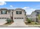 Charming two-story home with a two-car garage, brick facade, and landscaped front yard at 1542 Villageside Ct, Lawrenceville, GA 30043
