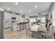 Open-concept kitchen with a large island, stainless steel appliances, and a seamless flow to the dining area at 1542 Villageside Ct, Lawrenceville, GA 30043