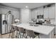 Modern kitchen featuring a spacious island, stainless steel appliances, and sleek gray cabinetry at 1542 Villageside Ct, Lawrenceville, GA 30043