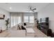 Cozy living room featuring a comfortable sectional sofa, large windows, and contemporary decor at 1542 Villageside Ct, Lawrenceville, GA 30043