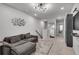Cozy living room featuring a comfortable gray couch, stylish decor, and a staircase leading to the upper level at 1542 Villageside Ct, Lawrenceville, GA 30043
