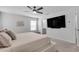 Spacious primary bedroom features a ceiling fan, flat screen tv, and ensuite bathroom at 1542 Villageside Ct, Lawrenceville, GA 30043