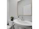 Stylish powder room featuring a pedestal sink, modern fixtures, and neutral decor at 1542 Villageside Ct, Lawrenceville, GA 30043