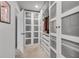 Large walk-in closet with custom shelving, drawers, and frosted glass doors for ample storage space at 1542 Villageside Ct, Lawrenceville, GA 30043