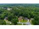 A beautiful neighborhood aerial view showcases mature trees surrounding well-maintained homes with landscaped yards at 5741 Stonekirk Walk Northwest, Acworth, GA 30101