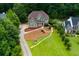 A stately two-story home with lush landscaping and a winding driveway nestled in a wooded neighborhood at 5741 Stonekirk Walk Northwest, Acworth, GA 30101
