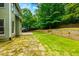 Expansive backyard featuring a stone patio, grassy lawn and plenty of trees at 5741 Stonekirk Walk Northwest, Acworth, GA 30101