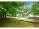 Picturesque backyard with mature trees, landscaping, a patio, and tiered landscaping at 5741 Stonekirk Walk Northwest, Acworth, GA 30101