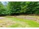 Extensive backyard featuring green grass, trees, a stone patio, and tiered landscaping at 5741 Stonekirk Walk Northwest, Acworth, GA 30101