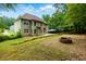 Backyard featuring a stone fire pit, patio, trees and tiered landscaping at 5741 Stonekirk Walk Northwest, Acworth, GA 30101