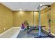 This gym area features tile floors and modern equipment with a weight rack for storage and organization at 5741 Stonekirk Walk Northwest, Acworth, GA 30101
