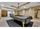 The open-concept basement features a billiard room, gym, and lounge area with tile floors at 5741 Stonekirk Walk Northwest, Acworth, GA 30101