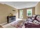 Relax in this lounge area of the basement with tile floors, a small fireplace, and a leather sofa at 5741 Stonekirk Walk Northwest, Acworth, GA 30101