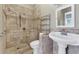 Accessible bathroom with tiled shower, handrails, toilet, and pedestal sink at 5741 Stonekirk Walk Northwest, Acworth, GA 30101