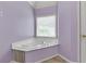 Cozy bathroom featuring a relaxing jacuzzi tub set under a window at 5741 Stonekirk Walk Northwest, Acworth, GA 30101