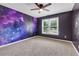 Unique bedroom featuring a vibrant galaxy mural, creating a fun and inspiring space at 5741 Stonekirk Walk Northwest, Acworth, GA 30101