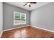 This bedroom has stylish wood floors and a window looking out into the yard at 5741 Stonekirk Walk Northwest, Acworth, GA 30101