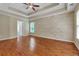 Bedroom with tray ceilings, accent wall and hardwood floors at 5741 Stonekirk Walk Northwest, Acworth, GA 30101