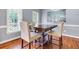 Stylish dining room with hardwood floors, featuring a modern light fixture and ample natural light from the windows at 5741 Stonekirk Walk Northwest, Acworth, GA 30101
