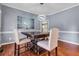 Elegant dining room with hardwood floors, showcasing a striking light fixture and contemporary decor at 5741 Stonekirk Walk Northwest, Acworth, GA 30101