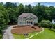 Attractive two-story home with a covered porch, nicely landscaped yard, and long driveway set among mature trees at 5741 Stonekirk Walk Northwest, Acworth, GA 30101