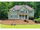 Stunning two-story home featuring an inviting front porch and picturesque landscaping, set among mature trees at 5741 Stonekirk Walk Northwest, Acworth, GA 30101
