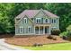 Inviting two-story home with a covered porch, traditional windows, and a beautifully landscaped front yard at 5741 Stonekirk Walk Northwest, Acworth, GA 30101