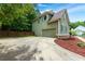Home exterior featuring a two car garage and mature landscaping at 5741 Stonekirk Walk Northwest, Acworth, GA 30101