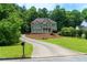 Gorgeous two-story home with a welcoming porch, mature trees, and a long driveway, offering serenity and privacy at 5741 Stonekirk Walk Northwest, Acworth, GA 30101
