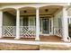 Charming covered front porch with decorative railing, columns and a wood deck, perfect for enjoying the outdoors at 5741 Stonekirk Walk Northwest, Acworth, GA 30101