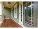 Inviting front porch with wood flooring, leading to the front door with sidelights, offering a warm welcome at 5741 Stonekirk Walk Northwest, Acworth, GA 30101