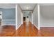 Hallway with hardwood floors, connecting various rooms and offering access to the main living areas at 5741 Stonekirk Walk Northwest, Acworth, GA 30101
