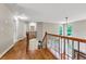 Upstairs hallway with hardwood floors and view to staircase at 5741 Stonekirk Walk Northwest, Acworth, GA 30101